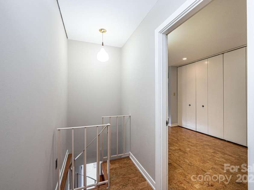 141 36th Avenue, Hickory, NC 28601.  MLS# CAR4317550, YatesRealty ID 677. Hallway off Primary with Spiral Staircase to Lower Level