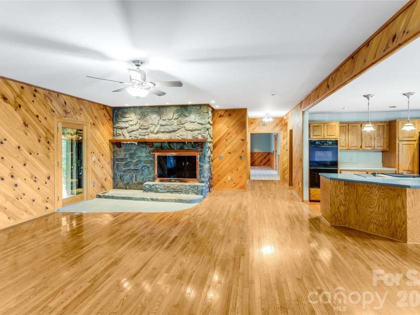 1087 Brigadoon Drive, Clyde, NC 28721.  MLS# CAR4362911, YatesRealty ID 6781. Den/Kitchen with fireplace