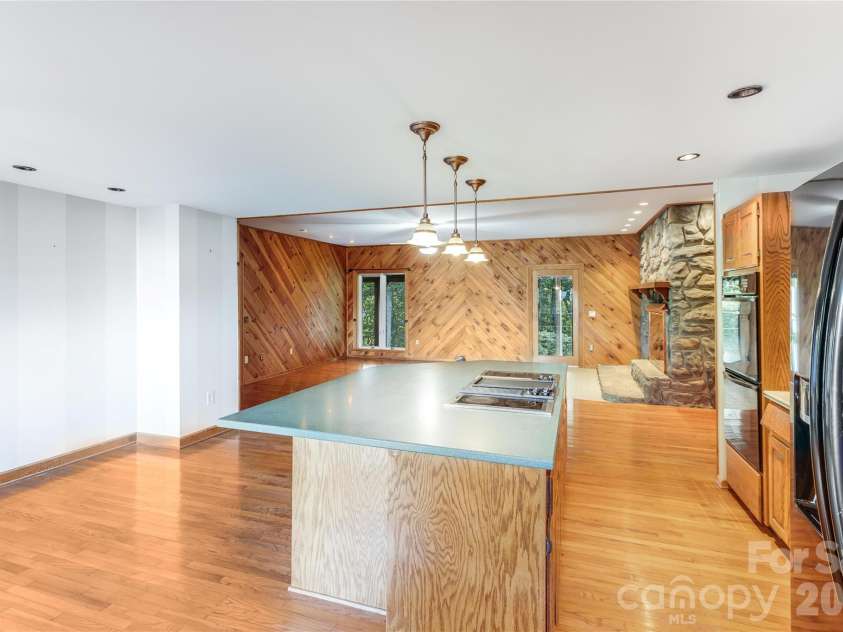 1087 Brigadoon Drive, Clyde, NC 28721.  MLS# CAR4362911, YatesRealty ID 6781. Kitchen and den