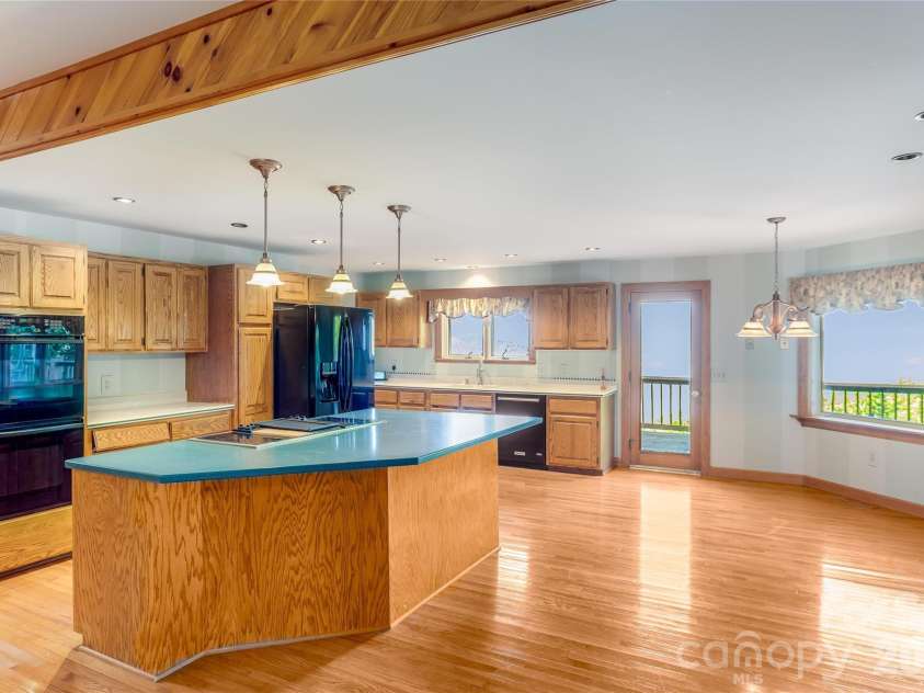 1087 Brigadoon Drive, Clyde, NC 28721.  MLS# CAR4362911, YatesRealty ID 6781. Open kitchen and den