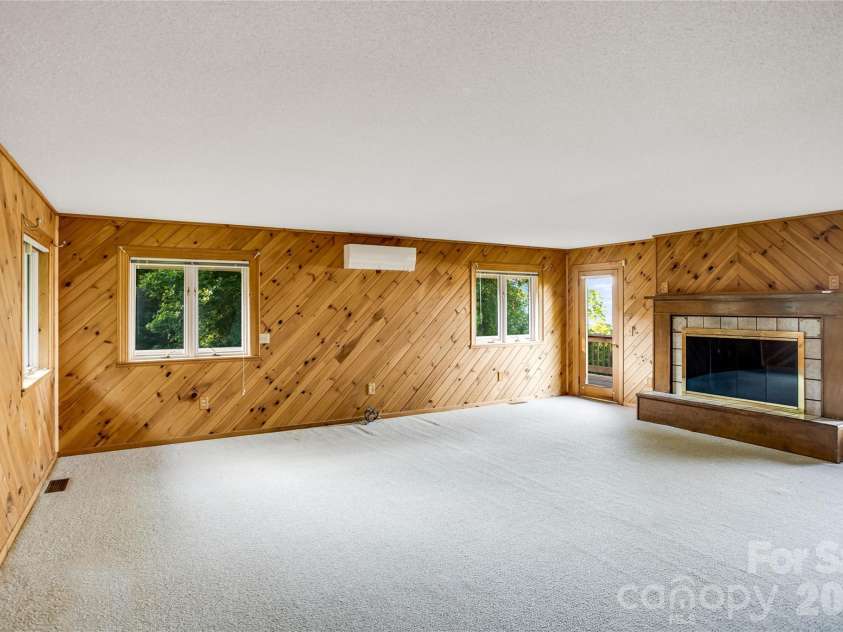 1087 Brigadoon Drive, Clyde, NC 28721.  MLS# CAR4362911, YatesRealty ID 6781. Primary bedroom with fireplace