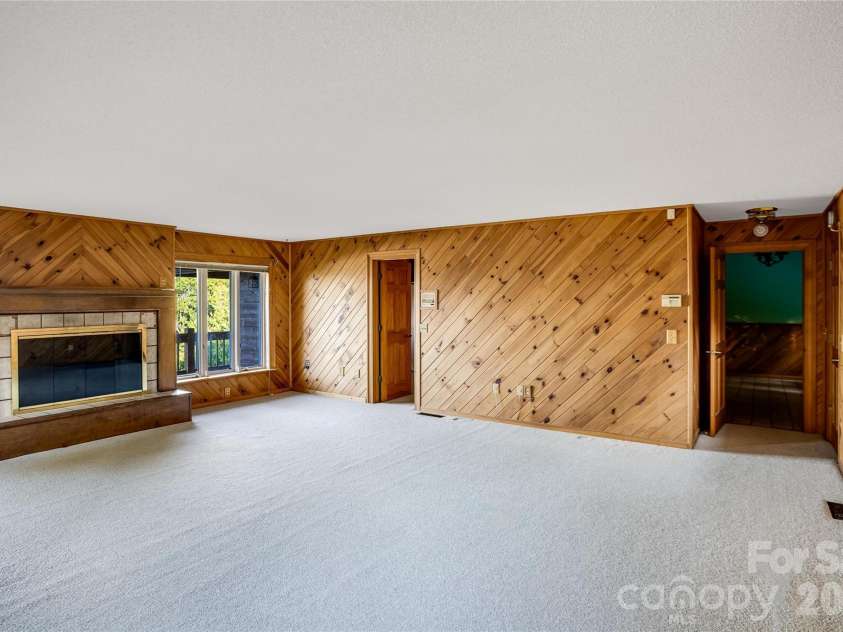 1087 Brigadoon Drive, Clyde, NC 28721.  MLS# CAR4362911, YatesRealty ID 6781. Spacious primary with fireplace and views