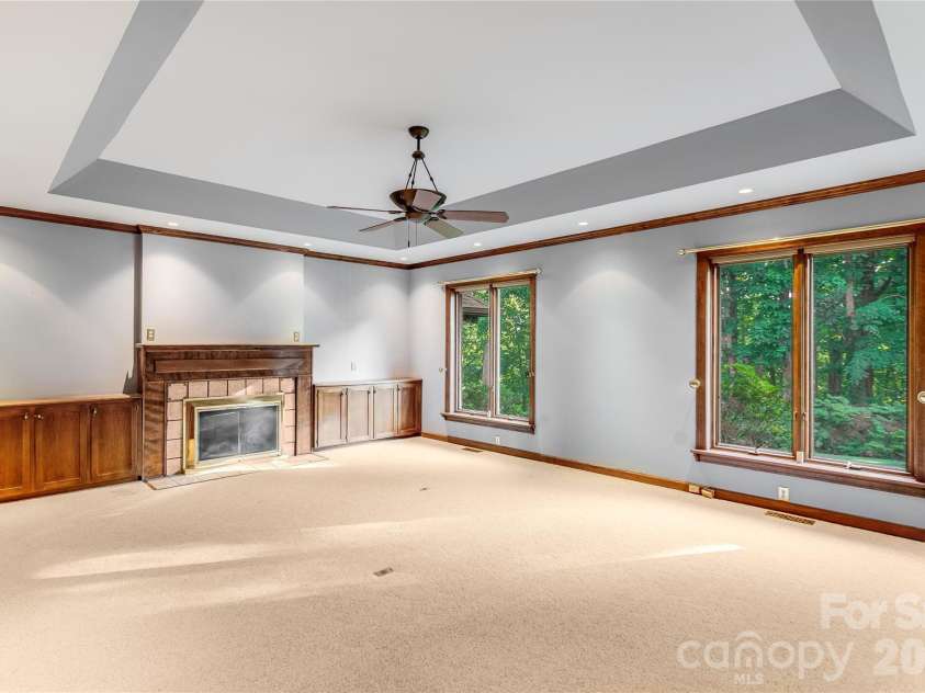 1087 Brigadoon Drive, Clyde, NC 28721.  MLS# CAR4362911, YatesRealty ID 6781. Tray ceiling and fireplace in library