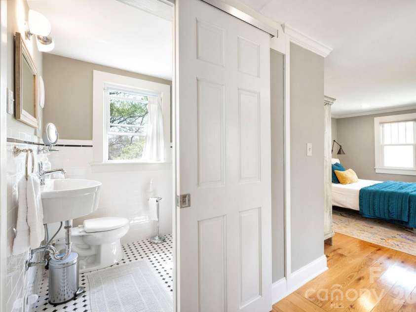 21 Craig Circle, Asheville, NC 28805.  MLS# CAR4359482, YatesRealty ID 6791. ADU - Sliding Barn Reveals Full Bath