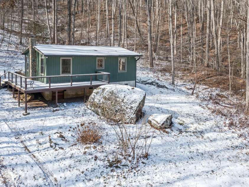 183 Stoney Fork Road, Barnardsville, NC 28709.  MLS# CAR4213332, YatesRealty ID 6809. Great updated cabin with boulder