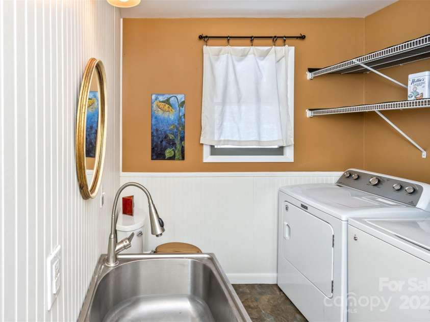 183 Stoney Fork Road, Barnardsville, NC 28709.  MLS# CAR4213332, YatesRealty ID 6809. Half bath in laundry area, also has sink with dual function