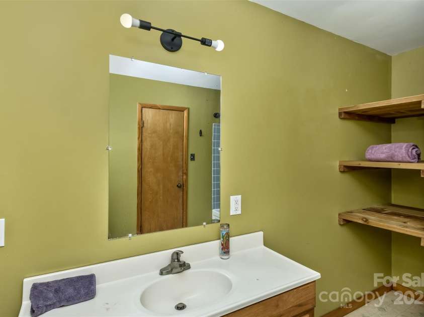 183 Stoney Fork Road, Barnardsville, NC 28709.  MLS# CAR4213332, YatesRealty ID 6809. Primary bath has plenty of storage