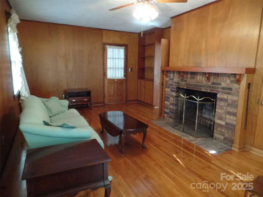 211 Walnut Avenue, Mount Holly, NC 28120.  MLS# CAR4210588, YatesRealty ID 6813. Den with Real Brick Fireplace and Hardwood Floors.
