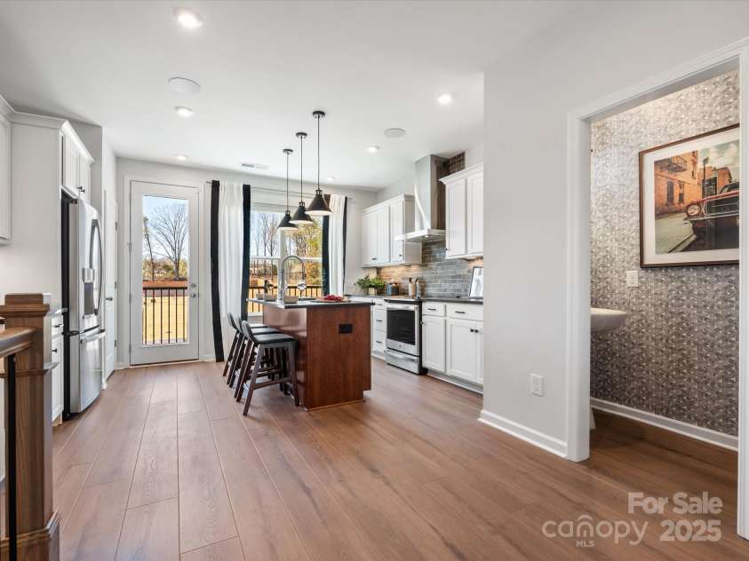 5628 Kingspan Drive, Charlotte, NC 28217.  MLS# CAR4211467, YatesRealty ID 6819. Collins Kitchen & Half Bath | Southmont *actual finishes, color scheme, orientation vary on this home. Furniture not included