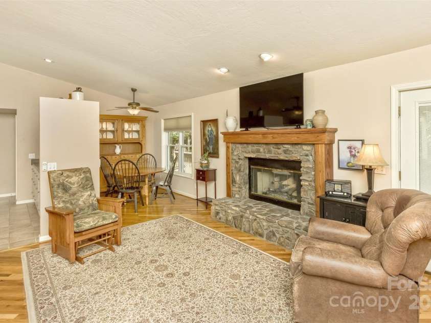 15 Beaverdam Knoll Road, Asheville, NC 28804.  MLS# CAR4283730, YatesRealty ID 684. The great room is cozy with a beautiful stone fireplace, oak mantel and natural gas logs. The mantel is designed with chases in the columns to hide wiring needs.