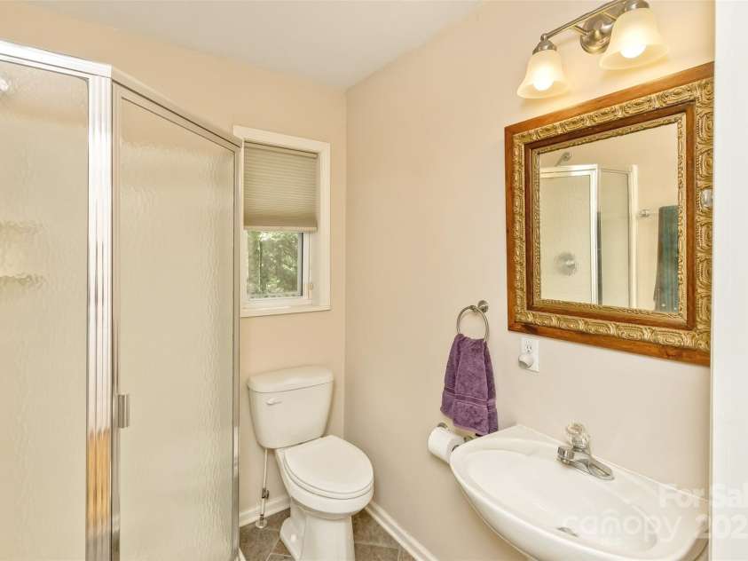 15 Beaverdam Knoll Road, Asheville, NC 28804.  MLS# CAR4283730, YatesRealty ID 684. The guest bathroom, complete with a corner shower, can be accessed from the great room, dining room and the second bedroom. The hallway doors can be closed to provide private access to this bathroom from the second b