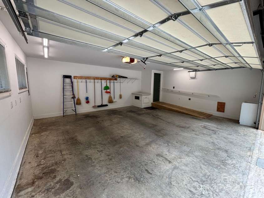 15 Beaverdam Knoll Road, Asheville, NC 28804.  MLS# CAR4283730, YatesRealty ID 684. The main level two-car garage features an accessible ramp into the laundry/kitchen hallway. The garage also features a laundry sink for easy cleanup after a day of gardening. The left side of the garage has sufficien