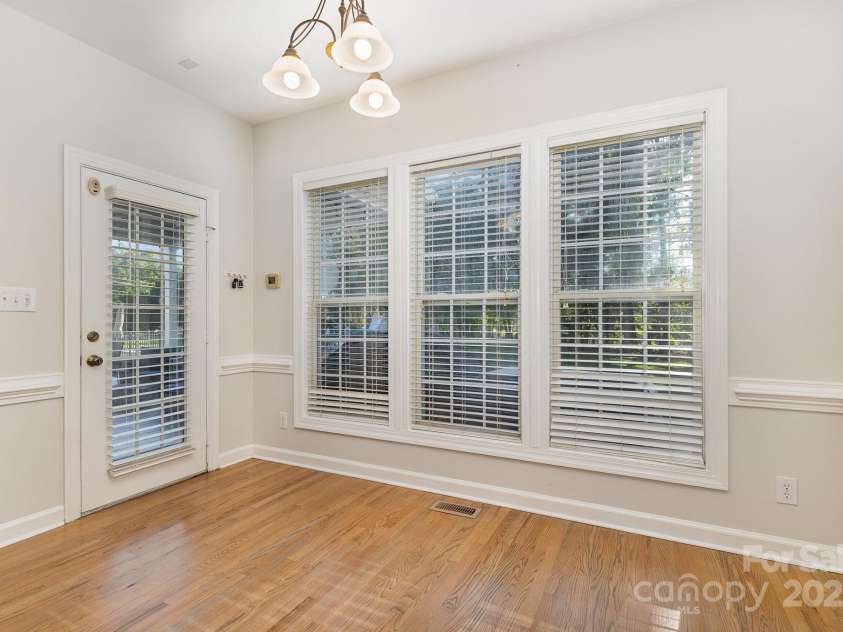 9404 Perimeter Court, Zebulon, NC 27597.  MLS# CAR4191333, YatesRealty ID 6842. Step into this bright and airy eat-in kitchen, where large windows flood the space with natural light and offer stunning views of the backyard and sparkling pool.