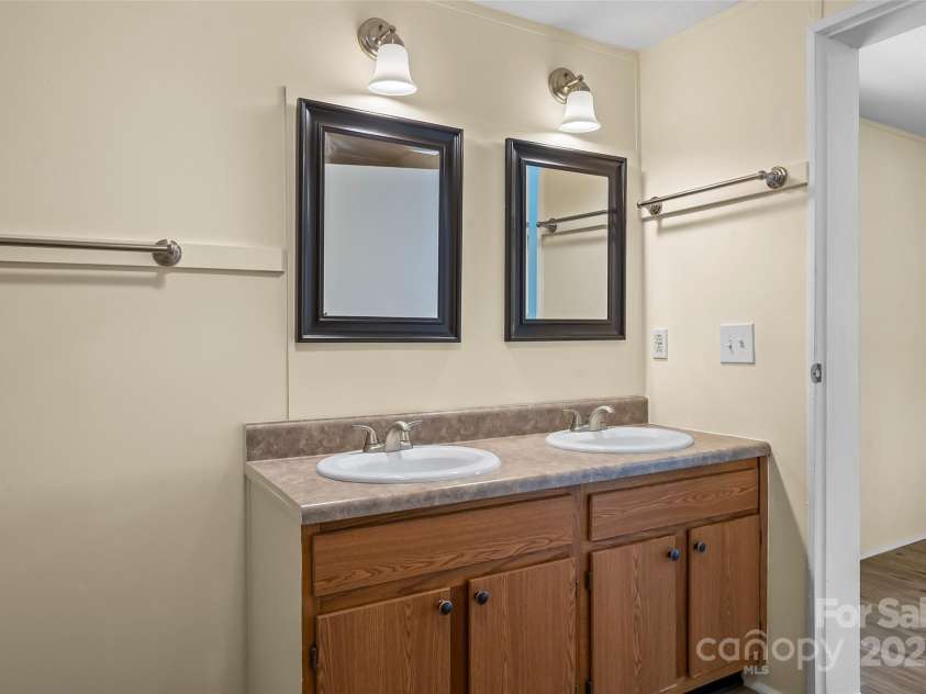 4 Saint Matthews Drive, Candler, NC 28715.  MLS# CAR4241573, YatesRealty ID 6844. Double vanity in primary bathroom