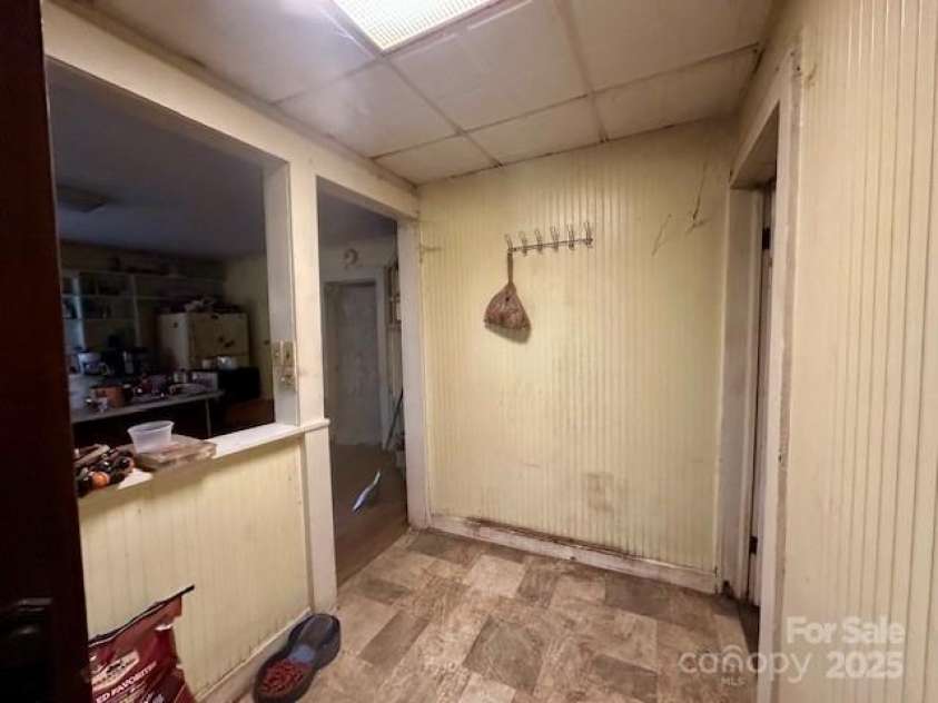 6000 Main Street, Salisbury, NC 28147.  MLS# CAR4248591, YatesRealty ID 6845. ACTUAL - BACK FOYER ENTRANCE /MUDROOM - KITCHEN IS TO THE LEFT AND DOOR TO RIGHT IS THE 3RD BEDROOM. HALF WALL ON THE LEFT COULD BE REMOVED TO ENLARGE THE KITCHEN.