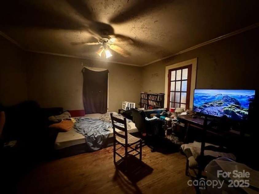 6000 Main Street, Salisbury, NC 28147.  MLS# CAR4248591, YatesRealty ID 6845. ACTUAL - FORMAL DINING ROOM - LOOK PAST TENNANT'S BELONGINGS TO SEE THE SPACE - HARDWOOD FLOORS, WOOD DOOR LEADS TO LIVING ROOM, WINDOW IS BEHIND THE MAKESHIFT CURTAIN - KITCHEN TO THE LEFT
