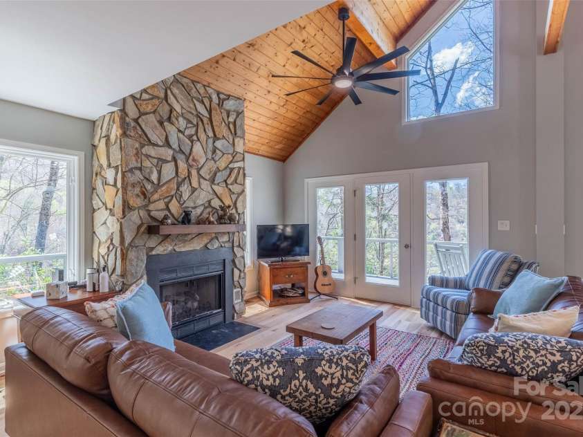 136 Dars Lane, Tuckasegee, NC 28783.  MLS# CAR4248083, YatesRealty ID 6851. Living room with deck access main level