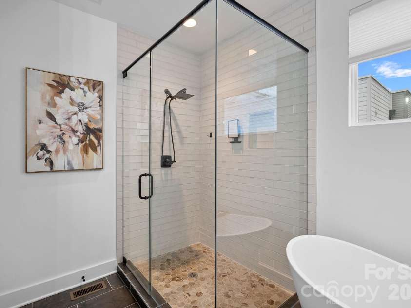306 Wesley Heights Way, Charlotte, NC 28208.  MLS# CAR4352519, YatesRealty ID 6867. Spa-like primary bathroom with oversized walk-in shower and soaking tub
