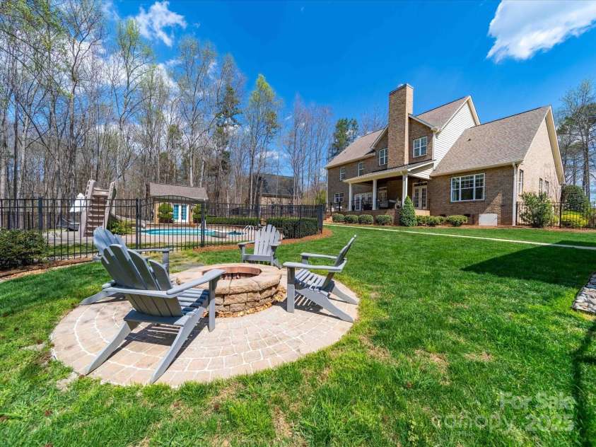 3024 Beaver Dam Drive, Monroe, NC 28110.  MLS# CAR4233437, YatesRealty ID 6869. Fire Pit by Pool and Detached Garage