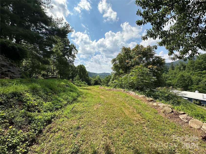 556 Blue Hill Road, Marshall, NC 28753.  MLS# CAR4154163, YatesRealty ID 6887. Cleared area heading towards garden.