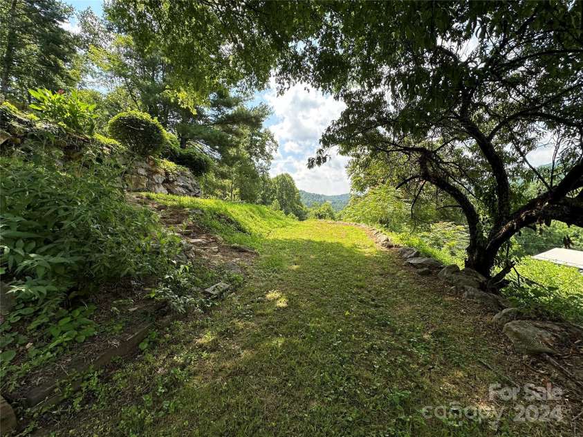 556 Blue Hill Road, Marshall, NC 28753.  MLS# CAR4154163, YatesRealty ID 6887. Easy terraced hillside with fruit trees