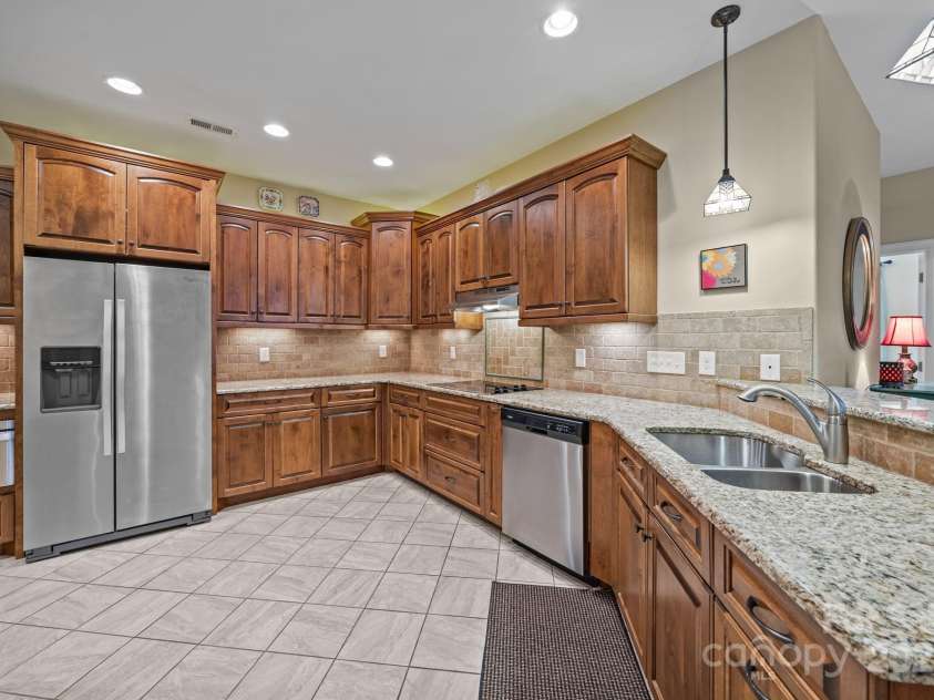 8657 Sonata Court, Denver, NC 28037.  MLS# CAR4321680, YatesRealty ID 690. Rich wood cabinetry and thoughtful lighting