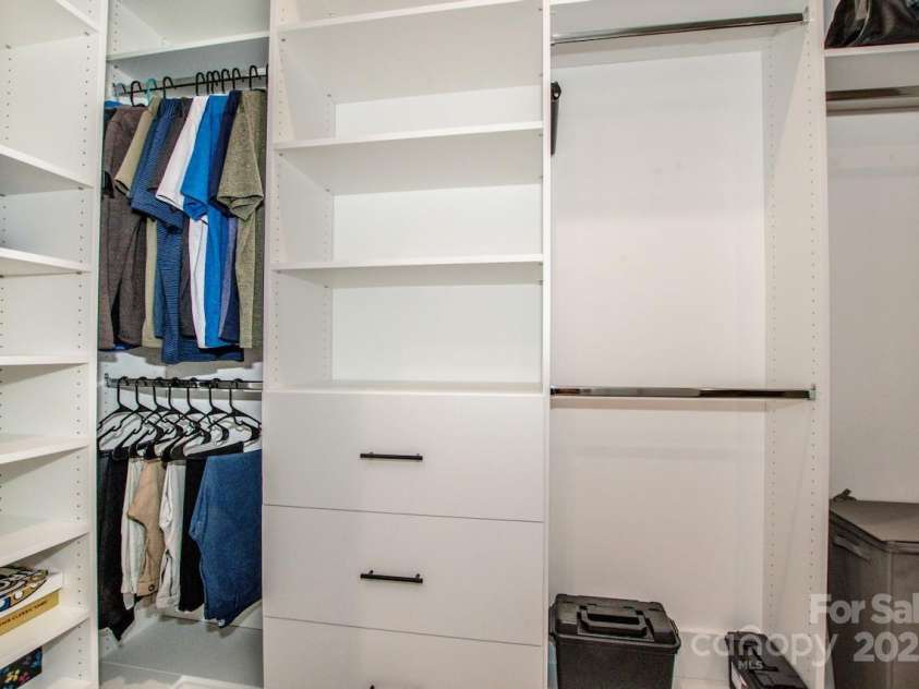 1270 Brawley School Road, Mooresville, NC 28117.  MLS# CAR4318407, YatesRealty ID 6902. New 2025 Primary Custom Built-in Closet with 6 drawers, Shoe shelves, hanging and Valet Rod and Belt rack 