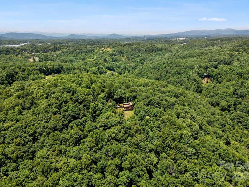 240+ and 252 General Hill Road, Flat Rock, NC 28731.  MLS# CAR4234844, YatesRealty ID 6906. Home sits on one of three potential hilltop home sites with wraparound views across the Green River valley. Property borders 18,000 protected acres of the Green River Game Lands.