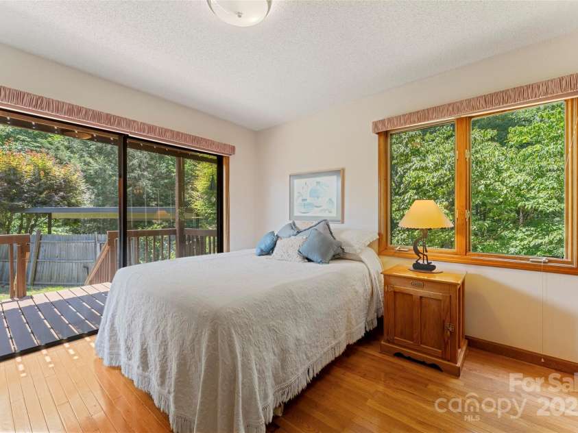 240+ and 252 General Hill Road, Flat Rock, NC 28731.  MLS# CAR4234844, YatesRealty ID 6906. Main level bedroom could serve as primary, with ensuite bathroom and deck access.