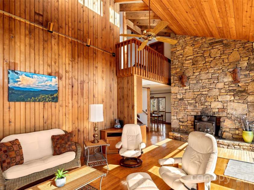 240+ and 252 General Hill Road, Flat Rock, NC 28731.  MLS# CAR4234844, YatesRealty ID 6906. The stone fireplace and wood provide a cozy warmth