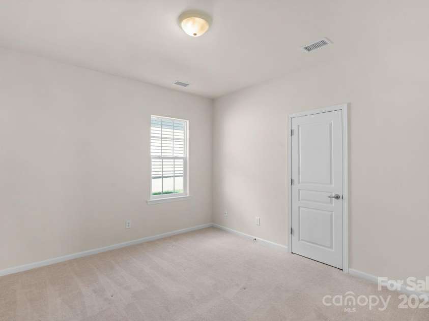 2136 Ashley River Road, Waxhaw, NC 28173.  MLS# CAR4243691, YatesRealty ID 6919. Secondary bedroom on the main floor with closet.