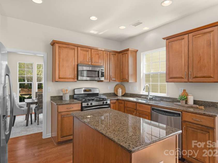 2136 Ashley River Road, Waxhaw, NC 28173.  MLS# CAR4243691, YatesRealty ID 6919. Well-equipped kitchen with granite counters, island, pantry & stainless appliances
