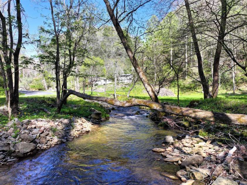 2180 Pigeon Roost Road, Green Mountain, NC 28740.  MLS# CAR4137054, YatesRealty ID 693. Pigeon Roost Creek looking toward the farmhouse