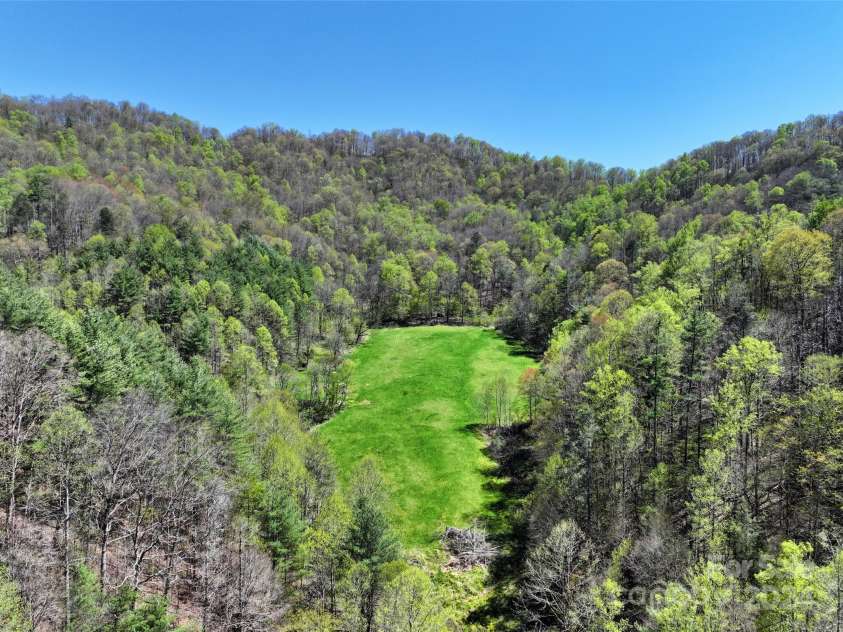 2180 Pigeon Roost Road, Green Mountain, NC 28740.  MLS# CAR4137054, YatesRealty ID 693. The hidden mountain meadow -- an ideal location for your dream home