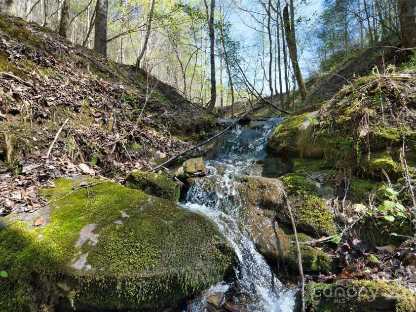2180 Pigeon Roost Road, Green Mountain, NC 28740.  MLS# CAR4137054, YatesRealty ID 693. Waterfall below the pond