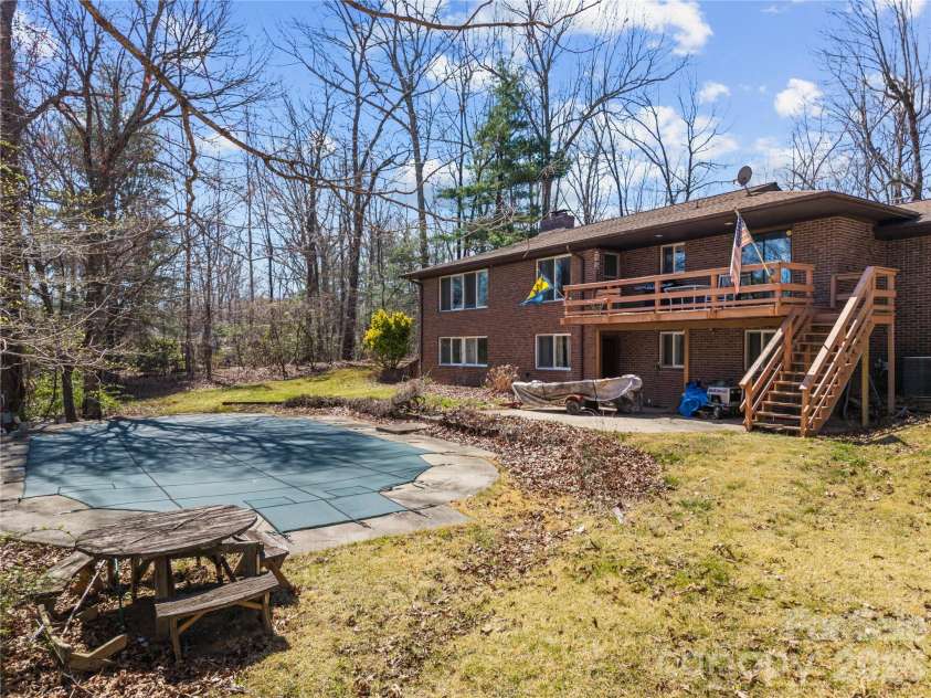 1086 Mine Gap Road, Zirconia, NC 28790.  MLS# CAR4361946, YatesRealty ID 6943. Backyard and pool