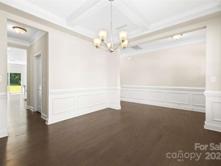 3023 Spinner Court, Denver, NC 28037.  MLS# CAR4142435, YatesRealty ID 6943. A formal dining room connected to a butler's pantry, leading to an oversized walk-in pantry to the right that opens into the kitchen, offering a seamless flow.