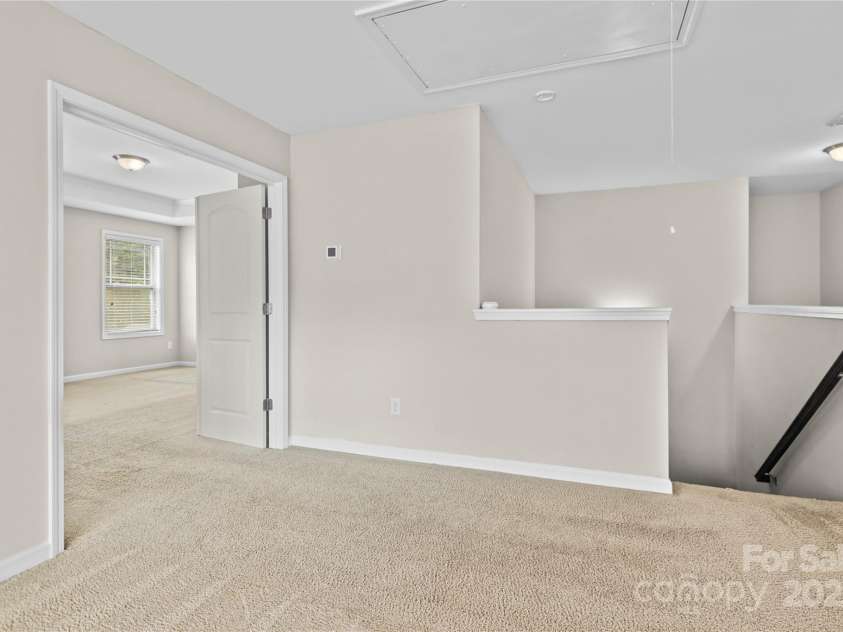 3023 Spinner Court, Denver, NC 28037.  MLS# CAR4142435, YatesRealty ID 6943. Ascending the stairs, to the right lies the grand primary bedroom, a spacious retreat exuding comfort and elegance, providing a serene haven for relaxation and rejuvenation.