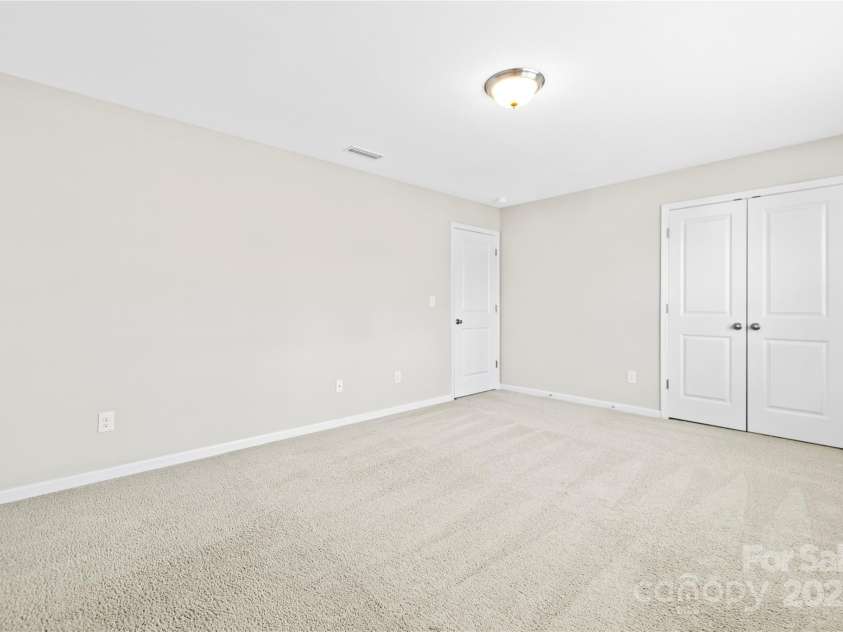 3023 Spinner Court, Denver, NC 28037.  MLS# CAR4142435, YatesRealty ID 6943. Bedroom #3 offers cozy carpeting underfoot and a spacious closet, providing comfort and ample storage space for its occupants.