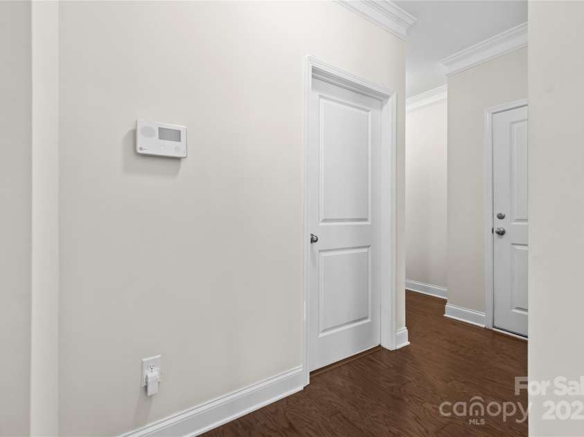 3023 Spinner Court, Denver, NC 28037.  MLS# CAR4142435, YatesRealty ID 6943. The main bedroom wing includes a comfortable guest bedroom, a full guest bathroom, a convenient drop zone, and a spacious two-car garage, providing both functionality and comfort.