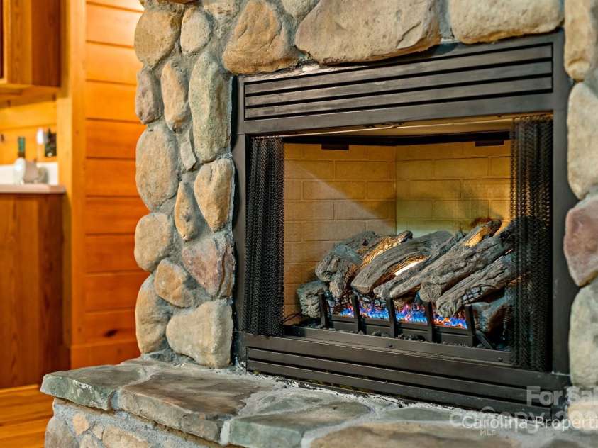 501 Bolt Road, Lake Lure, NC 28746.  MLS# CAR4241628, YatesRealty ID 6962. Beautiful stone fireplace with gas logs