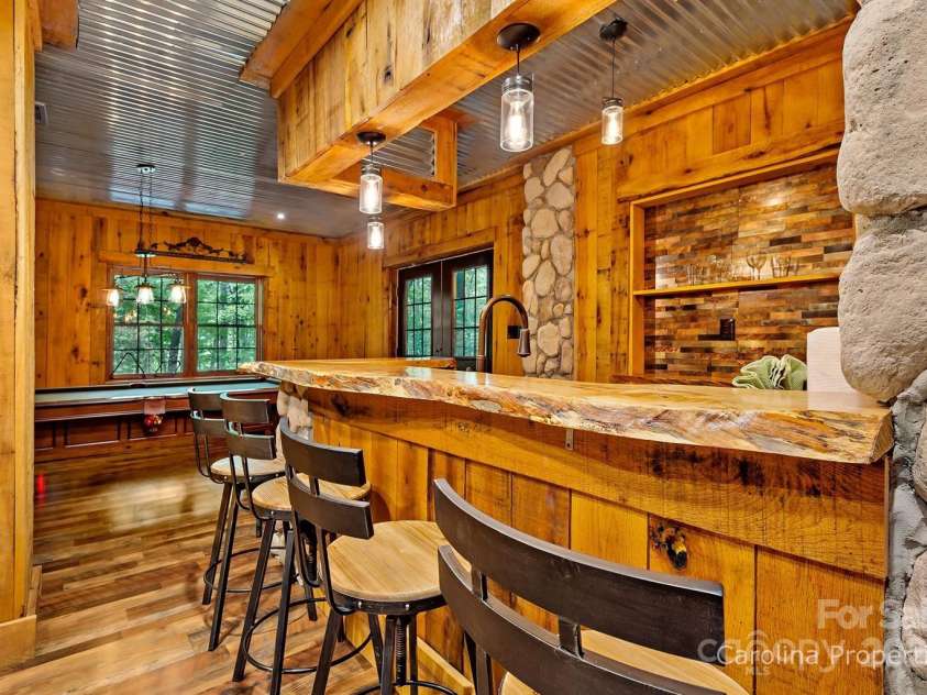 501 Bolt Road, Lake Lure, NC 28746.  MLS# CAR4241628, YatesRealty ID 6962. Lower-level custom bar space