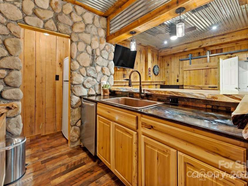 501 Bolt Road, Lake Lure, NC 28746.  MLS# CAR4241628, YatesRealty ID 6962. Lower-level custom bar space