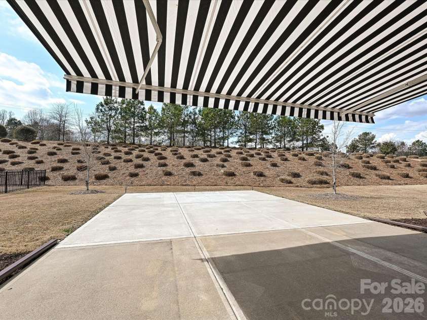 2004 Rockbrook Lane, Belmont, NC 28012.  MLS# CAR4355401, YatesRealty ID 6972. Rear Patio displaying the retractable awning 