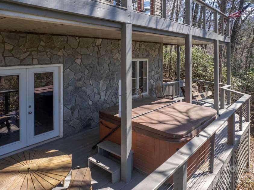 136 Dars Lane, Tuckasegee, NC 28783.  MLS# CAR4248083, YatesRealty ID 699. Basement deck with hot tub