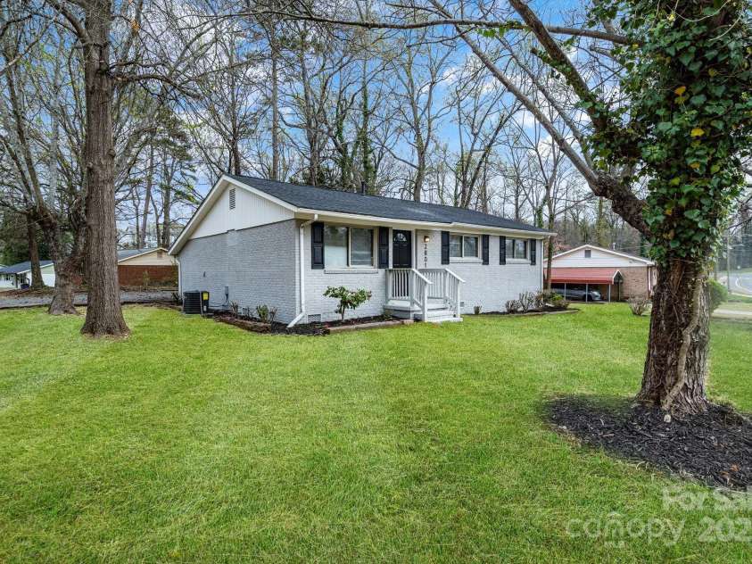 2801 Alleghany Street, Charlotte, NC 28208.  MLS# CAR4239718, YatesRealty ID 7009. Front of home showing large portion of front yard.
