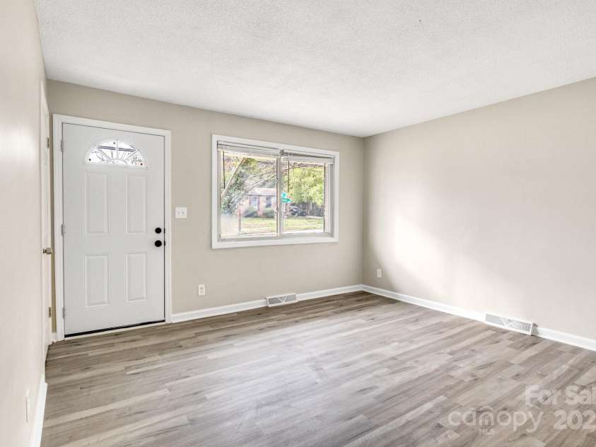 2801 Alleghany Street, Charlotte, NC 28208.  MLS# CAR4239718, YatesRealty ID 7009. Living room facing entry door.