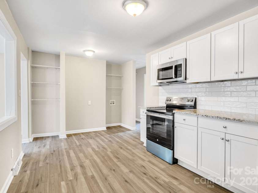 2801 Alleghany Street, Charlotte, NC 28208.  MLS# CAR4239718, YatesRealty ID 7009. Partial shot of kitchen. Entry on left leads to enclosed/finished sunroom; entry on right leads to hallway that connects the remainder of the home.