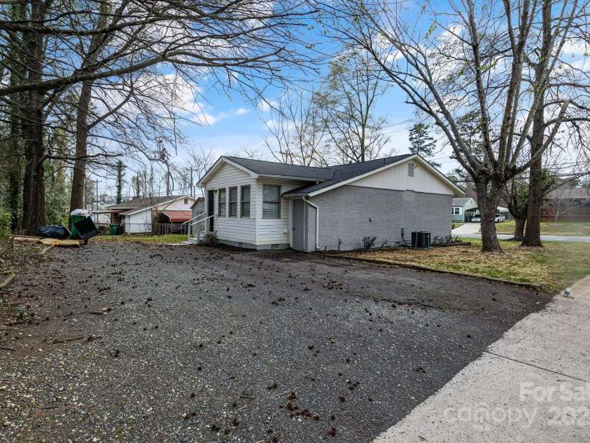 2801 Alleghany Street, Charlotte, NC 28208.  MLS# CAR4239718, YatesRealty ID 7009. Rear shot of home, emphasis on large, private gravel driveway