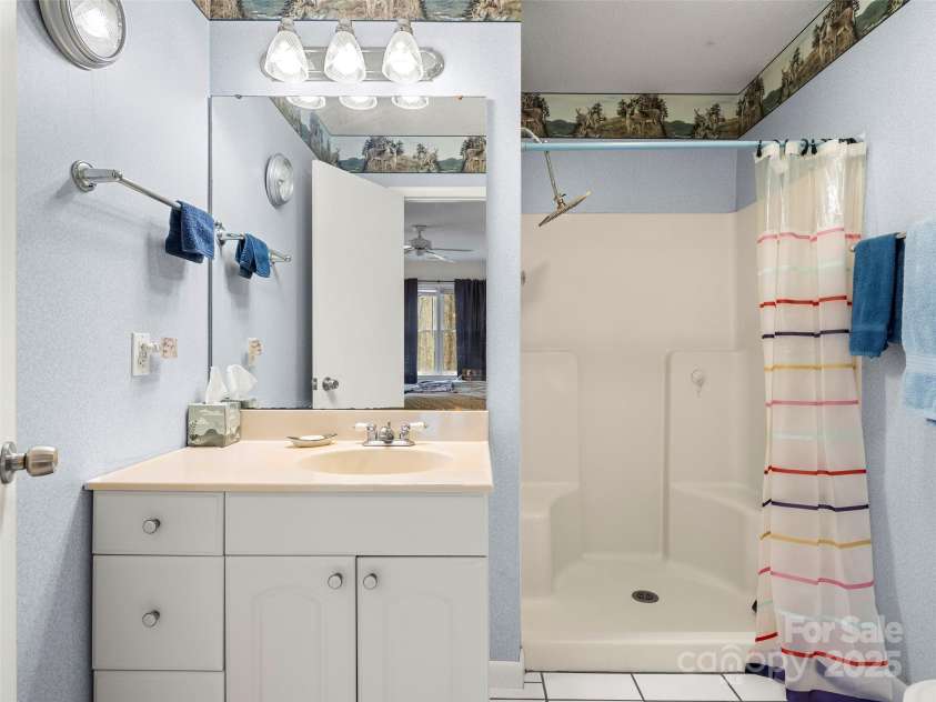 376 Ox Creek Road, Weaverville, NC 28787.  MLS# CAR4241579, YatesRealty ID 7011. Lower level primary bath